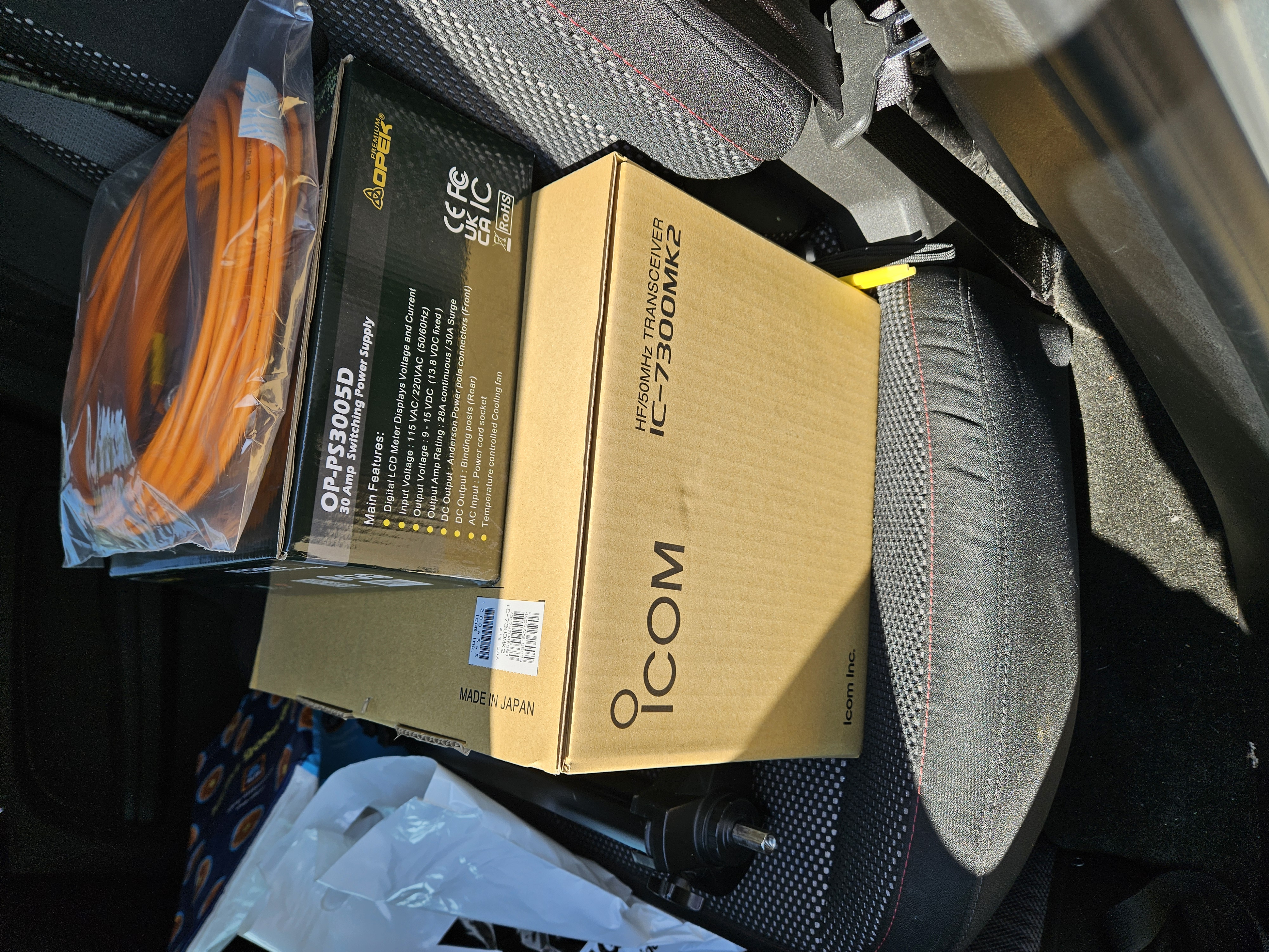 Icom IC-7300 Mk2 box with Opek power supply and coaxial cable sitting on top