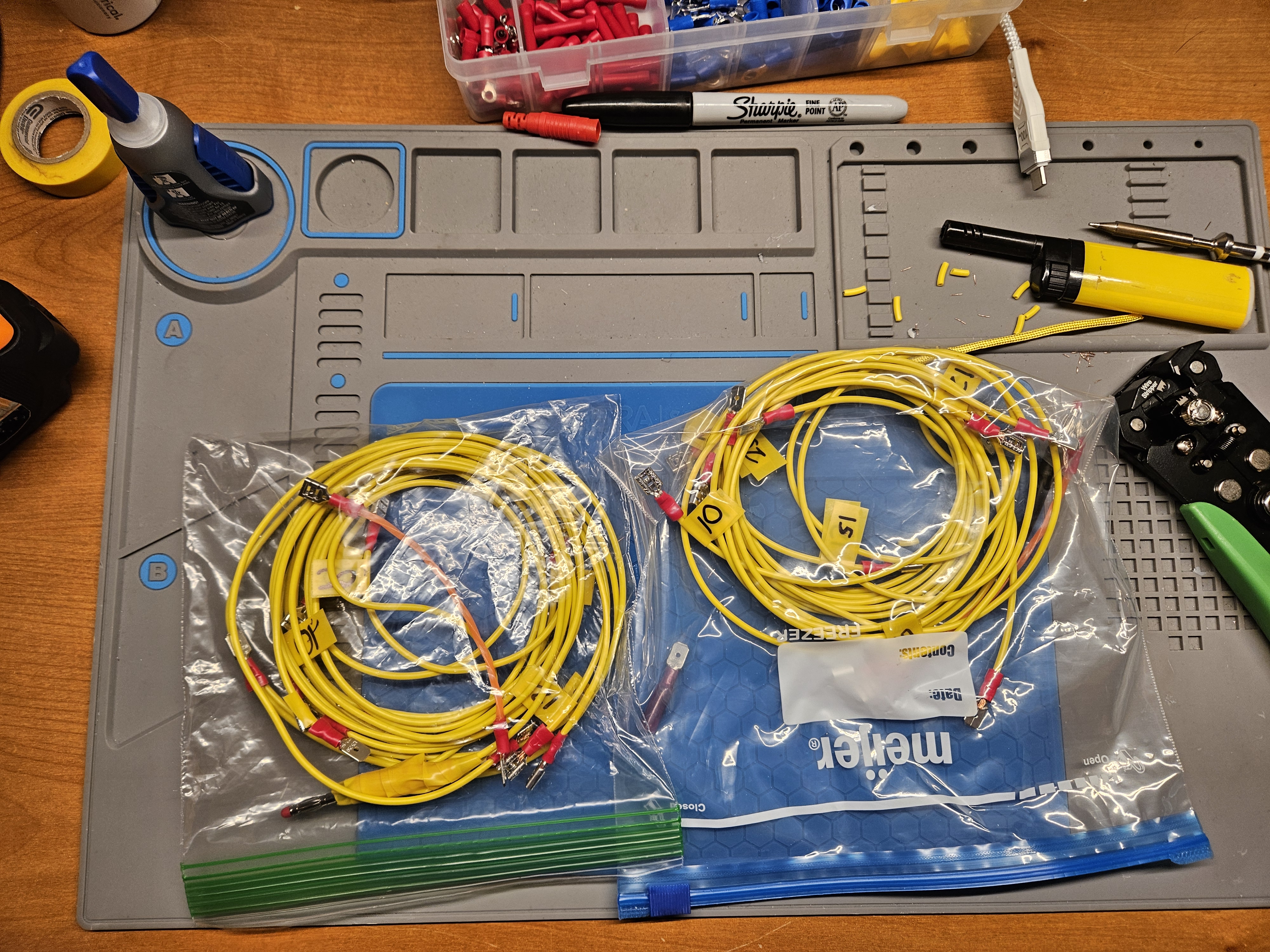 Two linked wire radial kits packed into ziploc bags on a workbench
